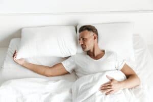 Sad man laying in bed and looking away